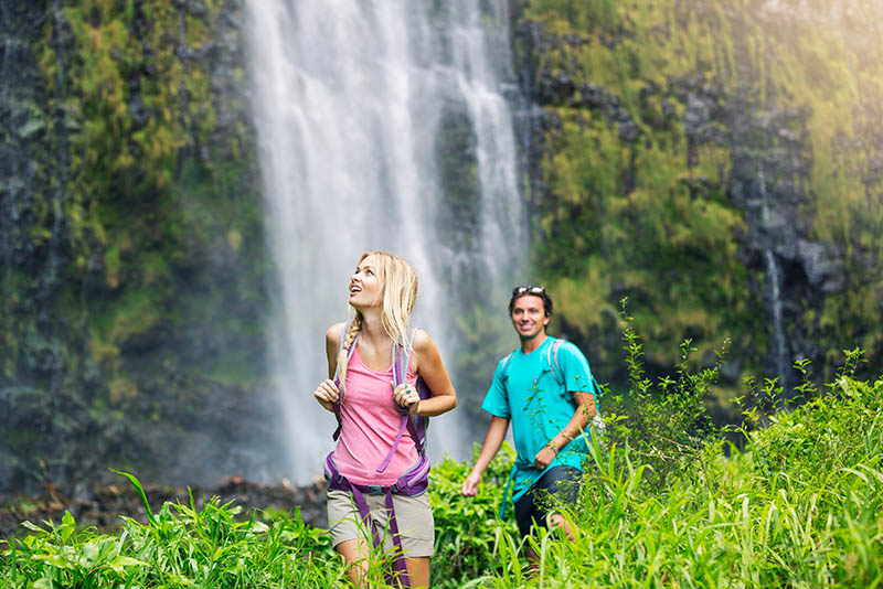 Couple hiking to waterfall in Hawaii